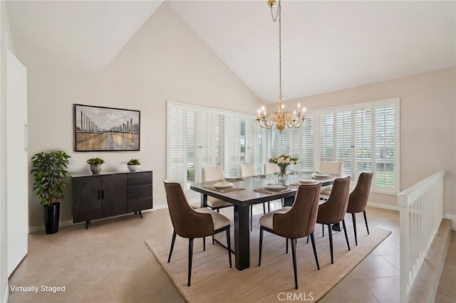 tiled dining space featuring high vaulted ceiling and a chandelier