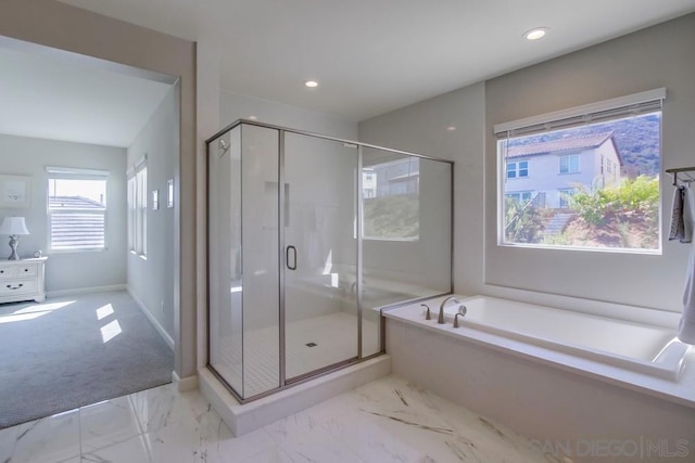 bathroom featuring separate shower and tub