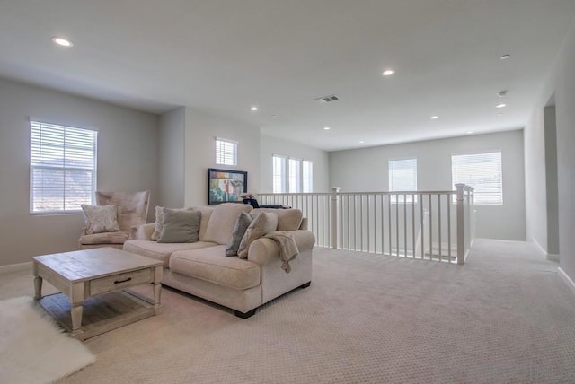 living room with plenty of natural light and light carpet