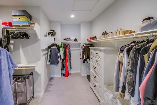 spacious closet with light carpet