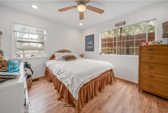 bedroom with ceiling fan and light hardwood / wood-style flooring