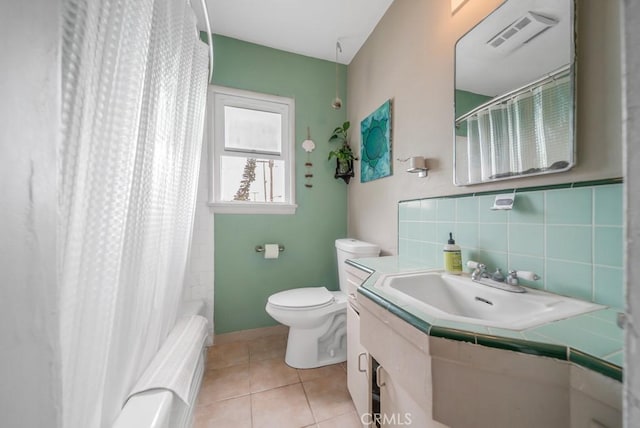 full bathroom with vanity, toilet, tile patterned flooring, and shower / bath combo with shower curtain