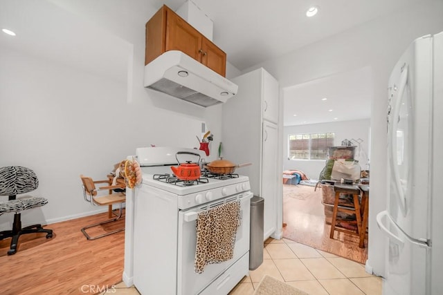 kitchen with white appliances and light tile patterned floors