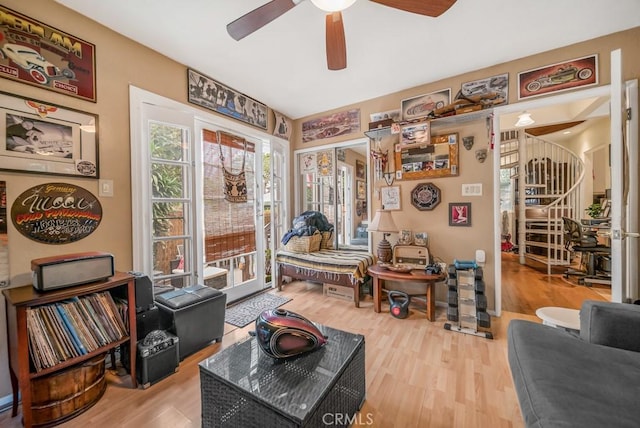 living area featuring wood-type flooring and ceiling fan