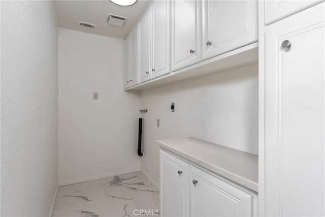 washroom featuring washer hookup, cabinets, and electric dryer hookup