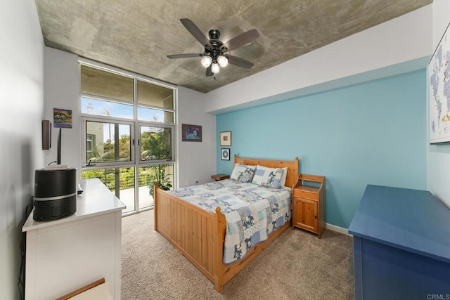 bedroom with carpet floors, floor to ceiling windows, baseboards, and a ceiling fan