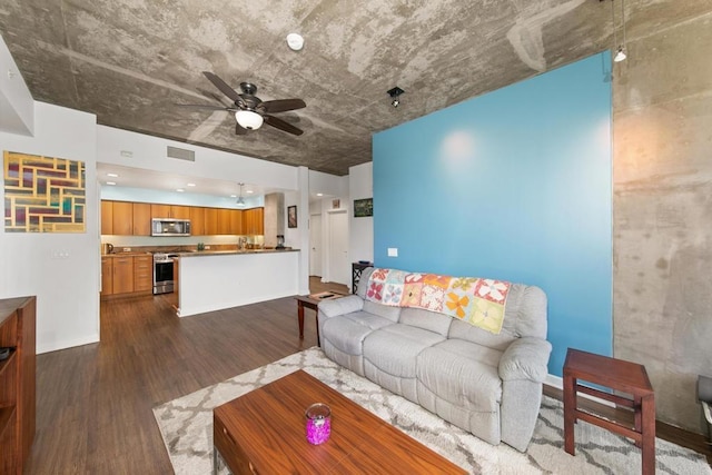 living room with baseboards, ceiling fan, visible vents, and dark wood-type flooring