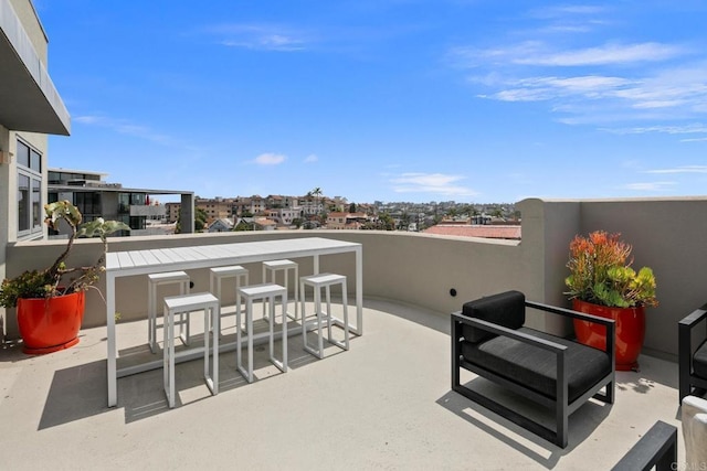 view of patio with a balcony and an outdoor bar