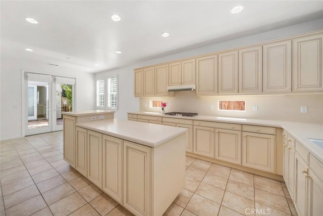 kitchen featuring cream cabinetry, gas stovetop, a kitchen island, and light tile patterned flooring