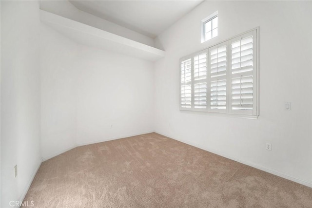 spare room featuring light colored carpet