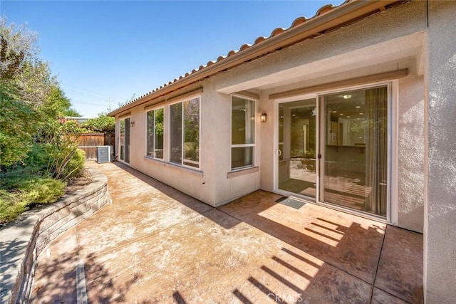 view of side of home featuring central air condition unit and a patio