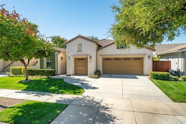 view of front of home with a garage and a front lawn