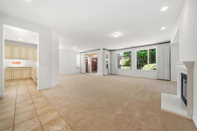 unfurnished living room featuring light carpet