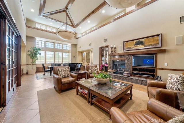 living room with high vaulted ceiling and light tile patterned floors