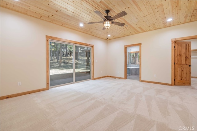 carpeted spare room featuring ceiling fan and wood ceiling