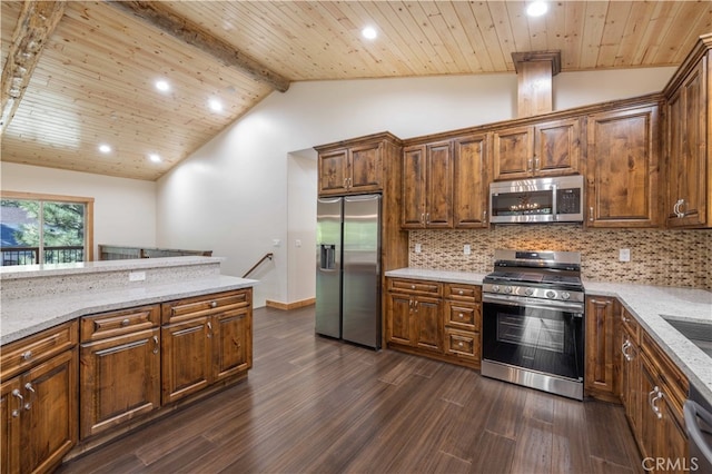 kitchen with stainless steel appliances, light stone countertops, and dark wood-type flooring