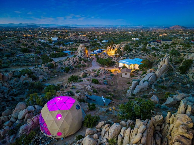 birds eye view of property with a mountain view