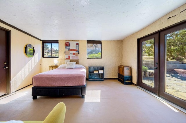 bedroom featuring french doors, multiple windows, access to outside, and crown molding