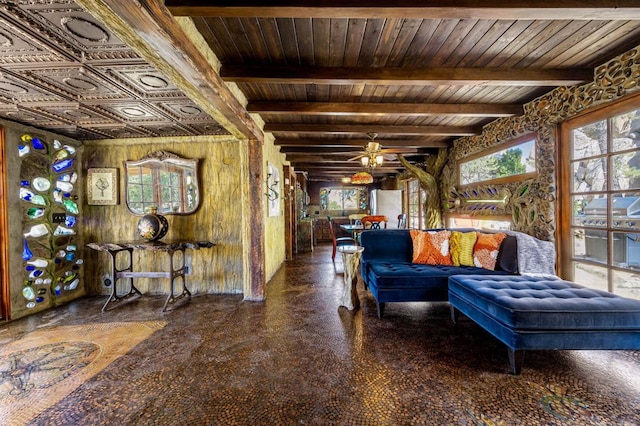 living room featuring wood ceiling, wood walls, ceiling fan, and beamed ceiling