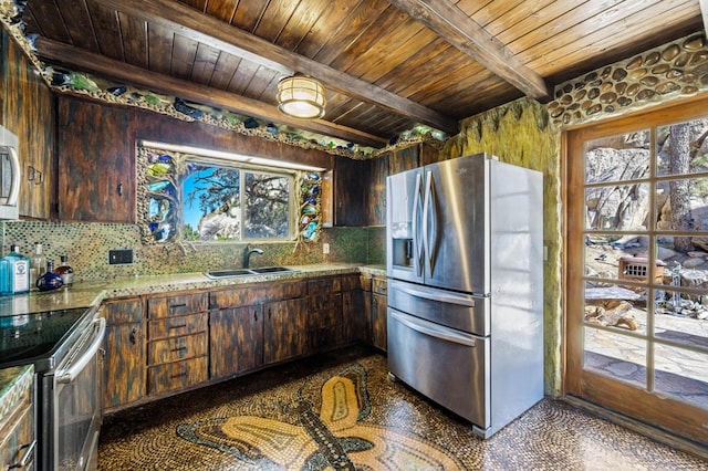 kitchen with stainless steel appliances, beam ceiling, a wealth of natural light, and sink