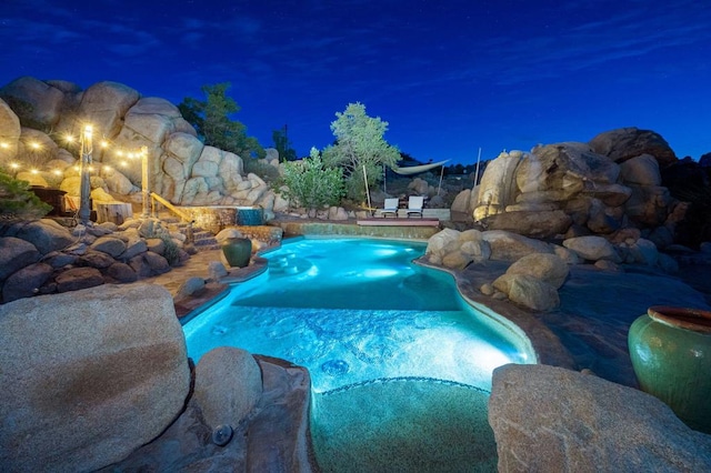 view of pool at night