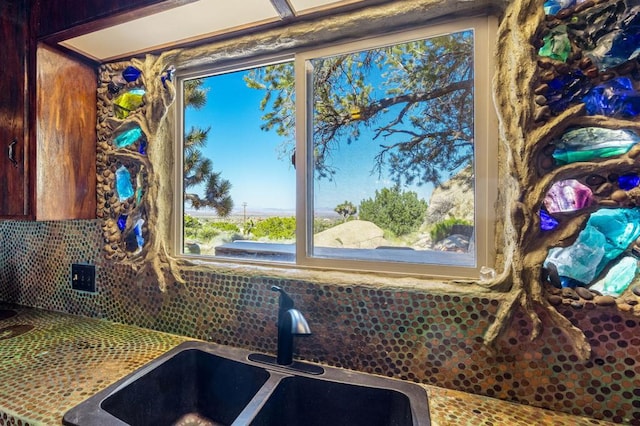 details featuring decorative backsplash and sink