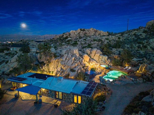 aerial view at dusk featuring a mountain view