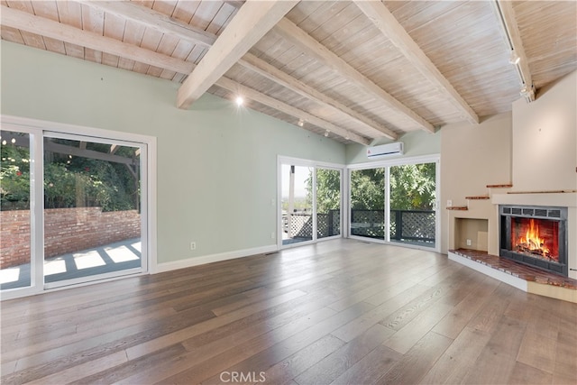 unfurnished living room featuring a wall mounted AC, track lighting, wood-type flooring, wooden ceiling, and lofted ceiling with beams