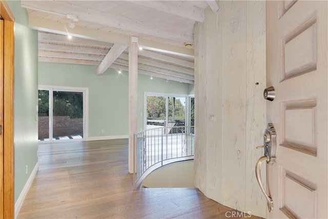 foyer entrance with vaulted ceiling with beams and wood-type flooring