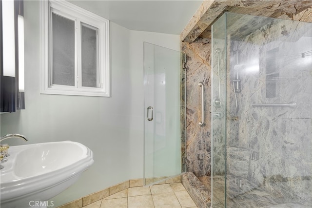 bathroom featuring sink, a shower with shower door, and tile patterned flooring