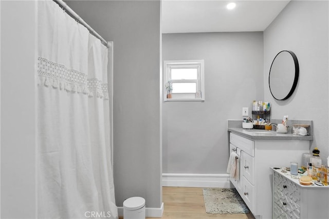 bathroom with vanity and hardwood / wood-style flooring