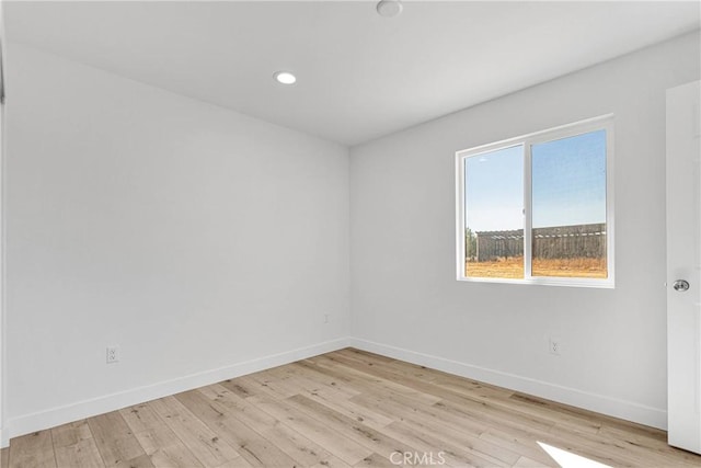 empty room with light hardwood / wood-style floors