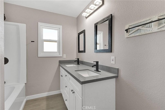 bathroom featuring vanity, wood-type flooring, and  shower combination