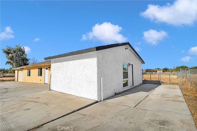 view of property exterior with a patio area