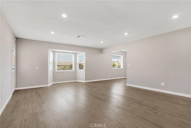 empty room featuring dark hardwood / wood-style floors and a wealth of natural light