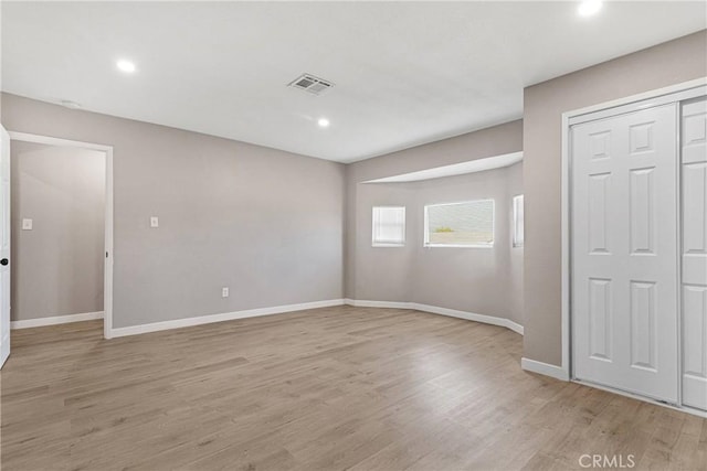 spare room with light wood-type flooring