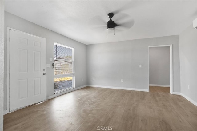 empty room with ceiling fan and light wood-type flooring