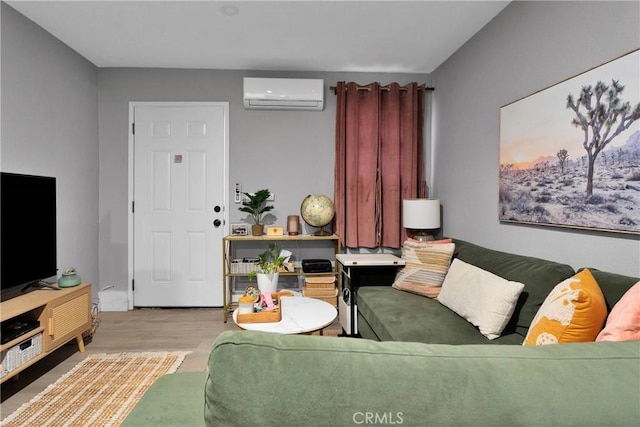 living room featuring an AC wall unit and light hardwood / wood-style flooring