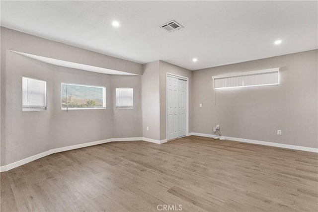 unfurnished room with light hardwood / wood-style flooring