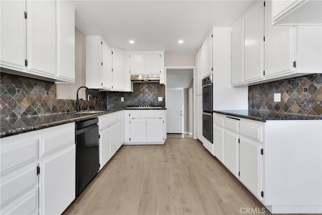 kitchen with black appliances, white cabinets, sink, light hardwood / wood-style flooring, and tasteful backsplash