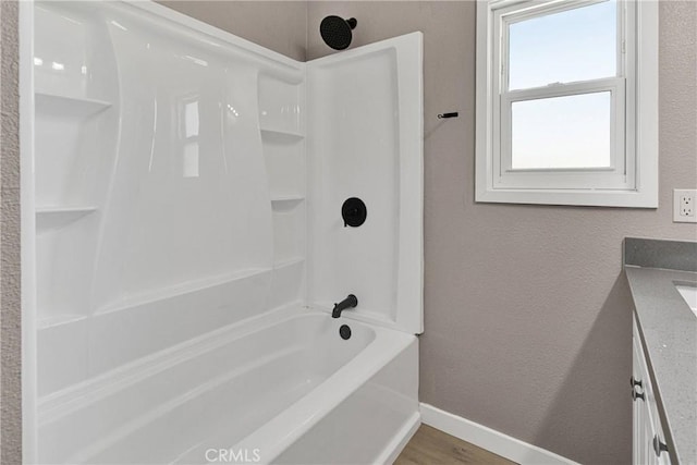 bathroom featuring shower / washtub combination, vanity, and hardwood / wood-style flooring