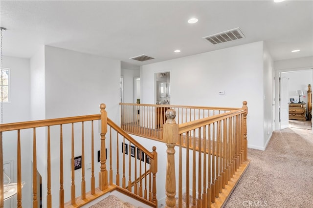 corridor featuring light colored carpet