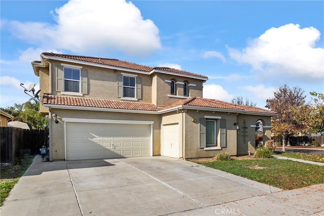 mediterranean / spanish-style house with a garage