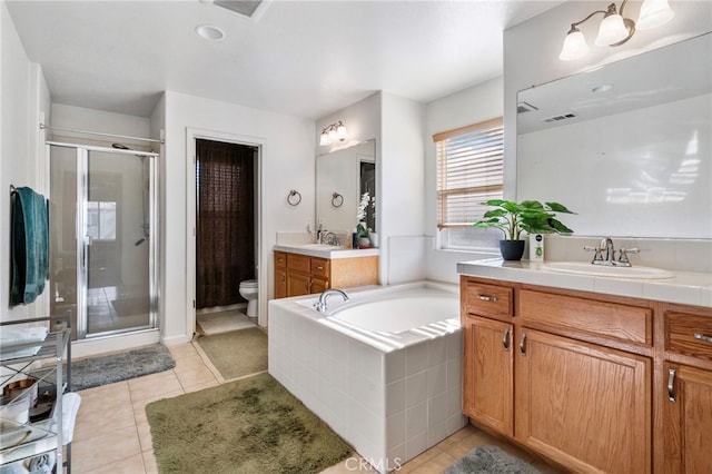 full bathroom with tile patterned floors, toilet, vanity, and shower with separate bathtub