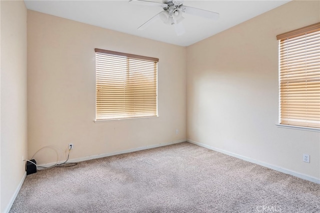 unfurnished room with ceiling fan and light colored carpet