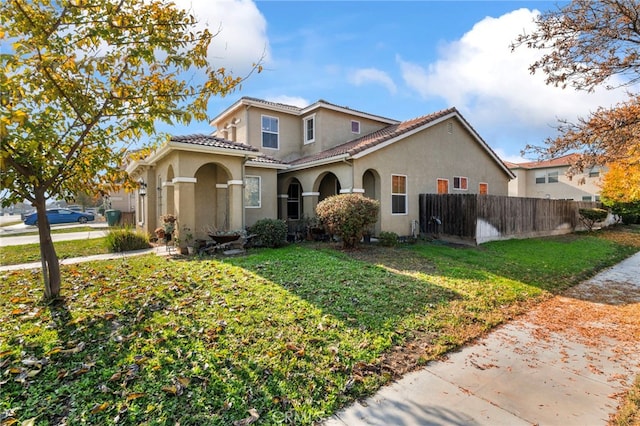 mediterranean / spanish house with a front lawn