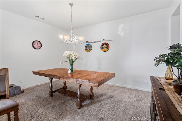 dining space featuring a chandelier and carpet floors