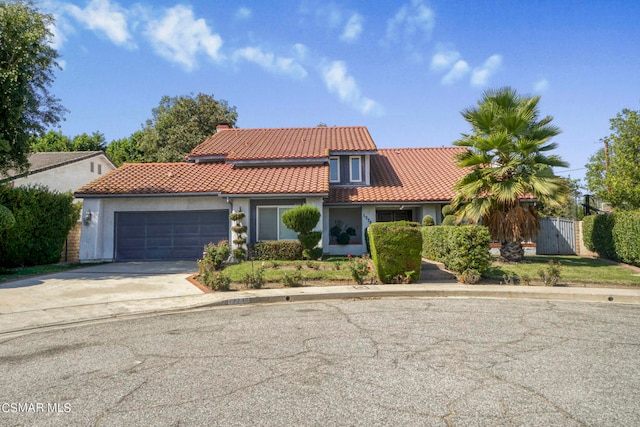 mediterranean / spanish-style home with a garage