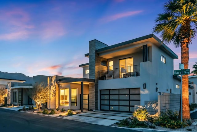 modern home with a balcony and a garage