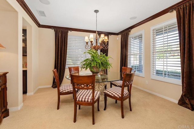 dining space with light carpet, an inviting chandelier, baseboards, and crown molding